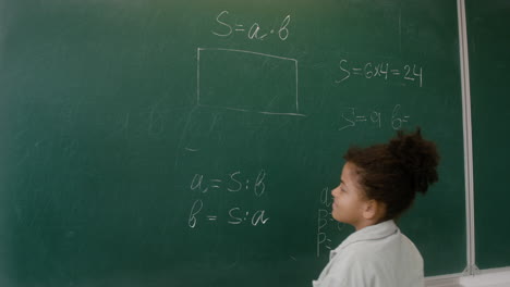 teacher and pupil at the blackboard.