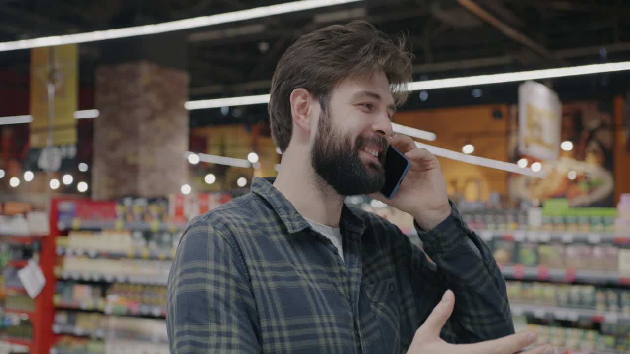 Man Shopping and Talking on Phone in Grocery Store
