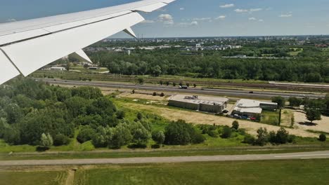 ground transportation in suburbs of warsaw, poland near airport, airplane passenger pov before landing