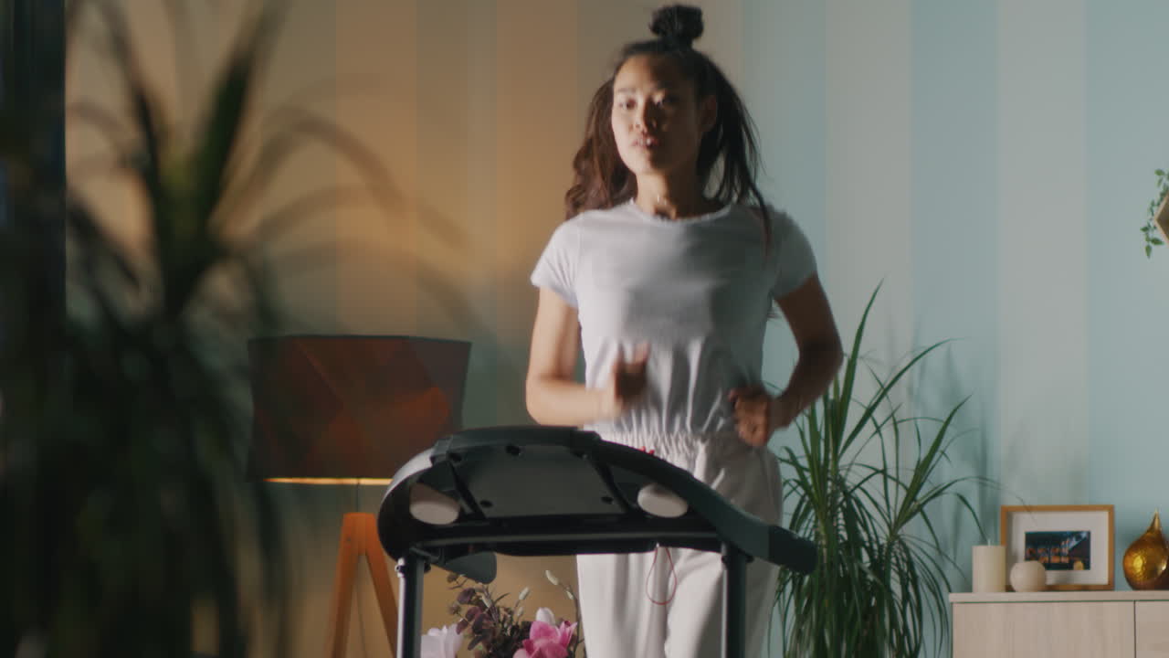 Woman Running on Treadmill at Home