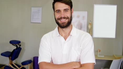 portrait of physiotherapist standing with arms crossed