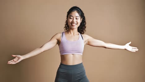 Fitness instructor performs various stretching and warm up exercises, showcasing different poses against a neutral beige backdrop, isolated on white