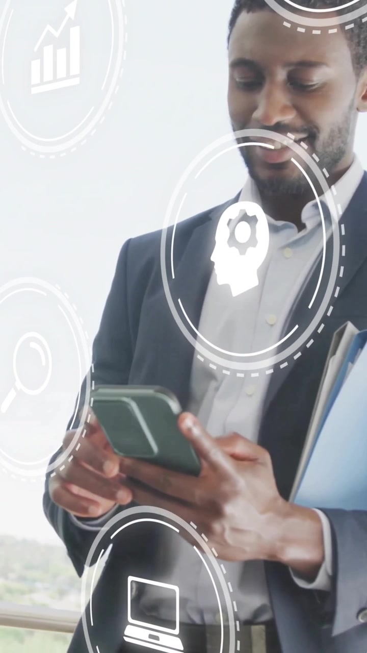 Animation of media icons over african american businessman using smartphone