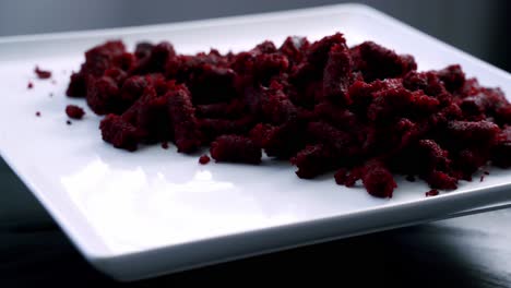 beet muffin pulp on rotating platter on white plate to make red velvet beet pulp muffin