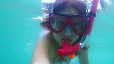 little redhead child girl have fun exploring underwater environment with snorkel and diving mask