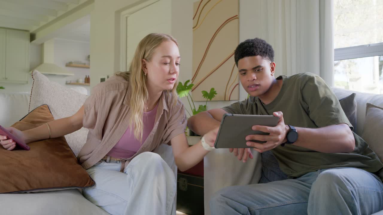 Vertical video: Woman leaning in, man tapping tablet, initiating animated tech UI for viewing