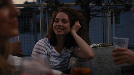 caucasian woman spending evening together at the roof top party.