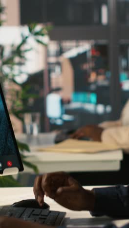 vertical video manager chatting with office worker in videoconference using tablet