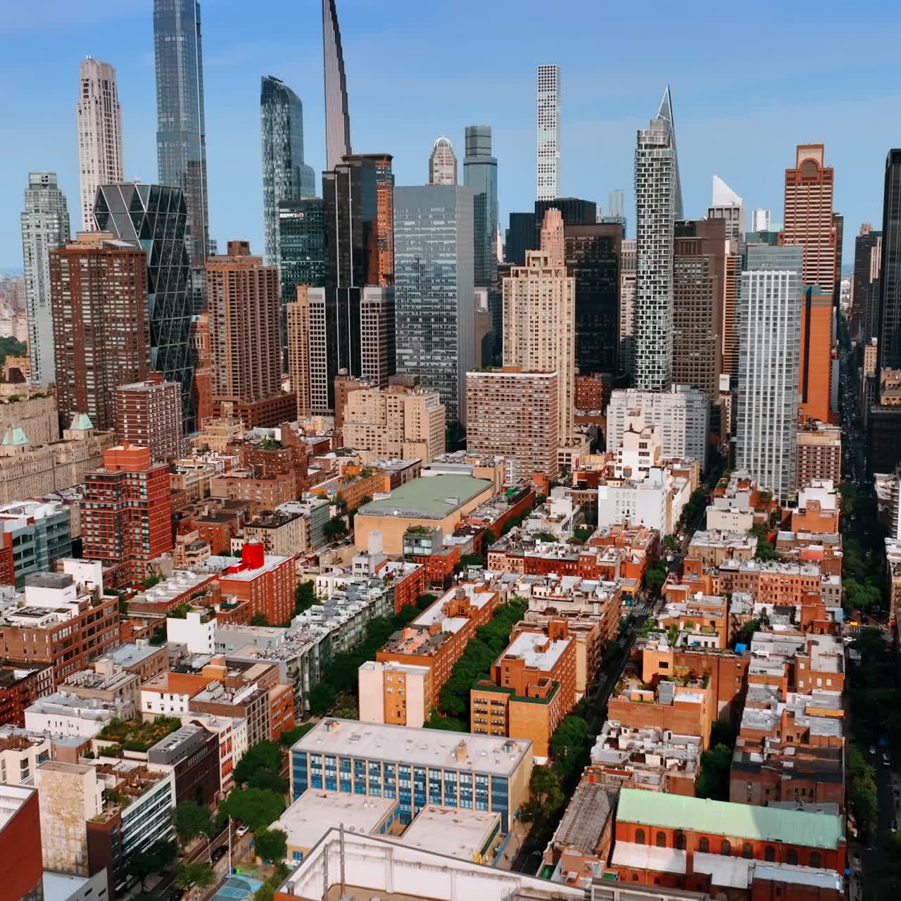 Sunny cityscape of New York from aerial view. Drone footage approaching stunning skyscrapers