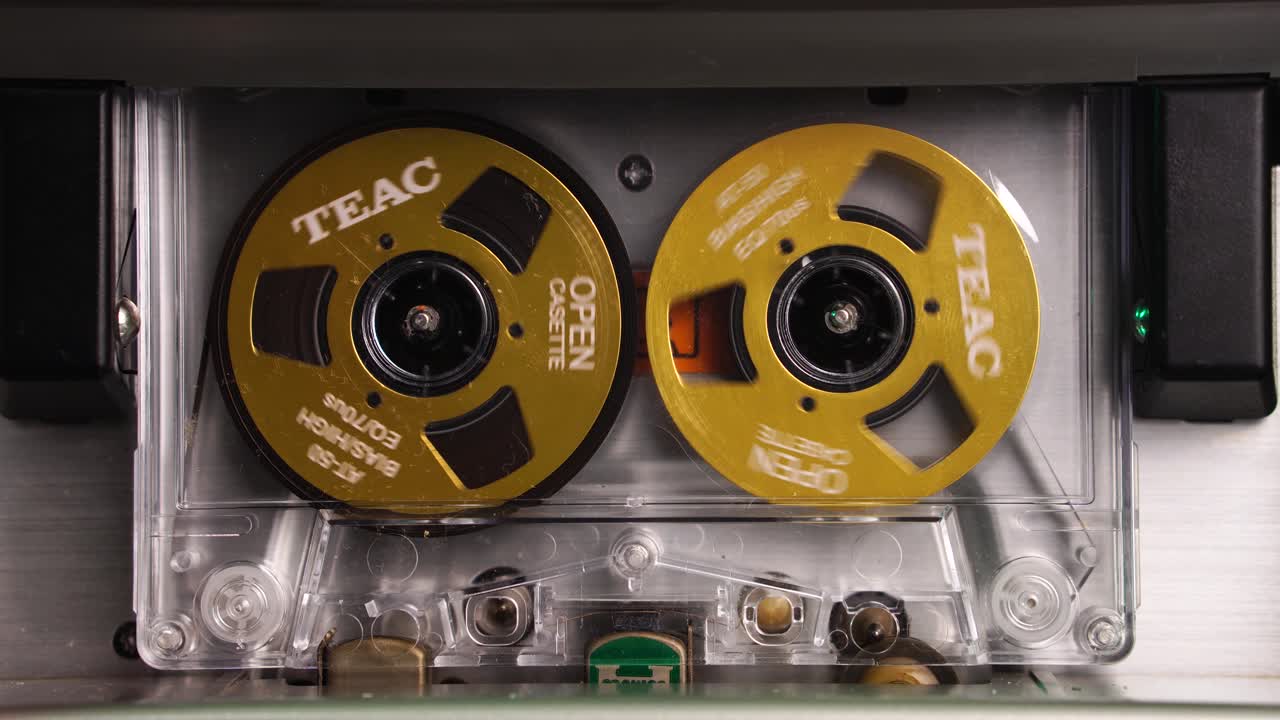 Vintage TEAC Audio Cassette Tape Spinning Reels During Playback or Recording, Close Up