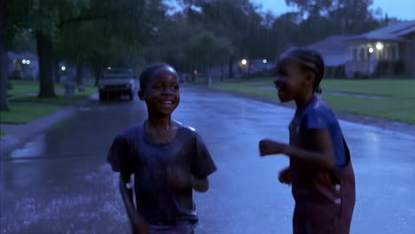 children playing happily in the rain on a street