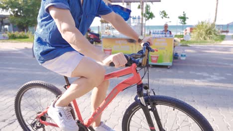 young man riding a bike on vacation.