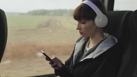 student girl scrolling on smartphone during bus ride