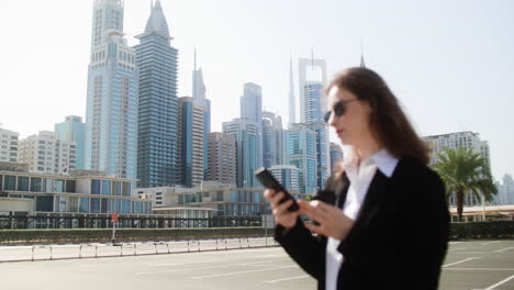 Elegant-businesswoman-with-phone-outdoors