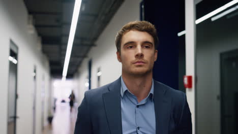 pensive employee walking office hallway closeup. tired man executive leaving