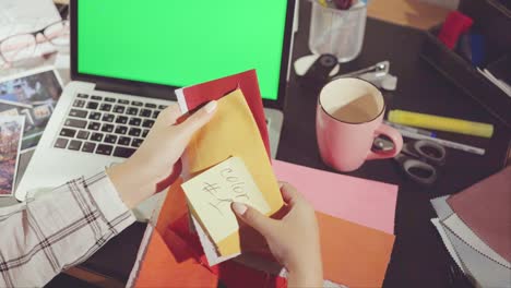 woman working on design project at a desk
