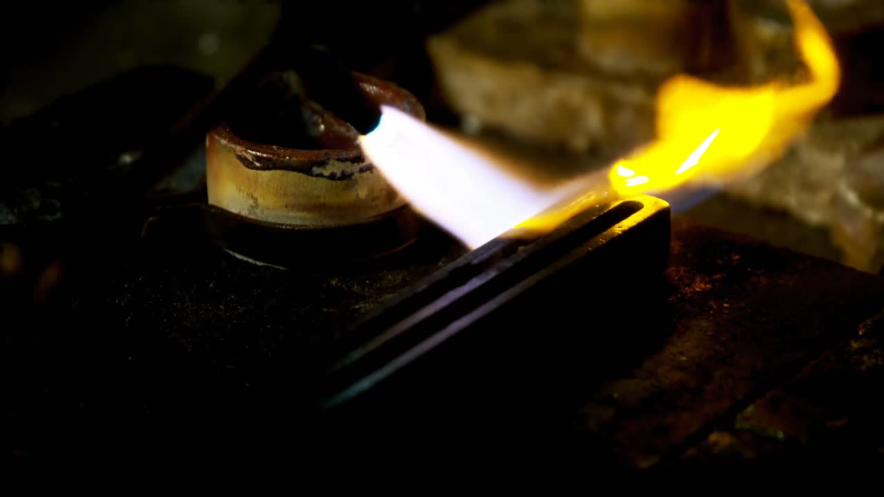 Welding torch is being used to melt jewellery in workshop 4k