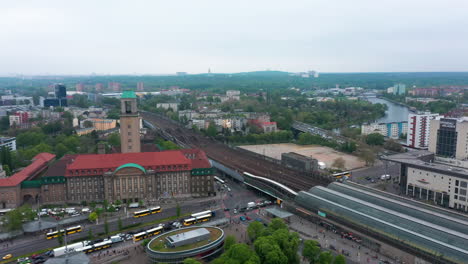 Aerial-shot-of-historic-city-hall-building-near-train-station-at-shopping-centre.-Urban-neighbourhood-in-background.-Berlin,-Germany