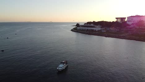 solar-flare-and-orbiting-view-of-a-lone-boat-on-the-mighty-Bosphorus-Strait-in-Istanbul-Turkey