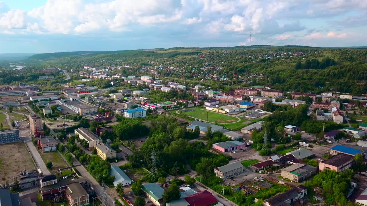 Aerial View of a Town with River and Hills