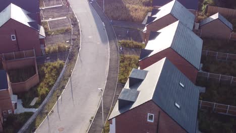 Aerial-rooftop-view-morning-sunrise-over-British-suburban-housing-development-building-site