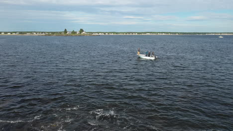 aerial tracking footage of fly fishing from a small boat at saco bay, maine