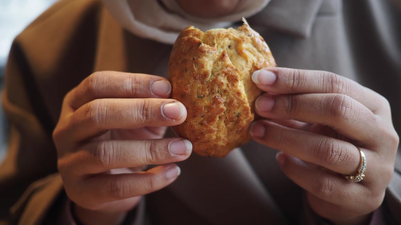 Person Holding a Freshly Baked Savory Scone