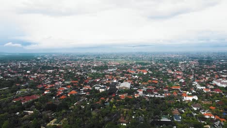 Beautiful-cinematic-Sanur-beach,-Bali-drone-footage-with-interesting-landscape,-fishing-boats,-village-houses,-hotels,-resorts-and-calm-weather