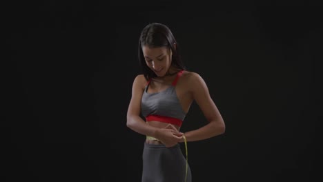 woman measuring her waist