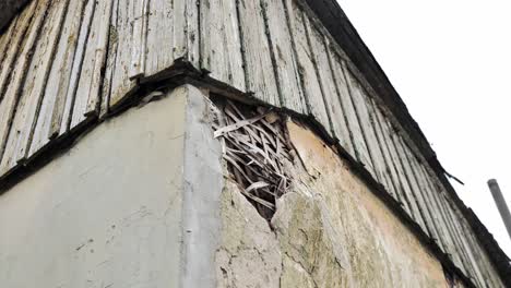 close up, decaying structure where plaster peels off from wooden framing, latvia