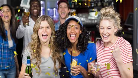 animation of gold confetti falling over happy diverse group of friends drinking in bar