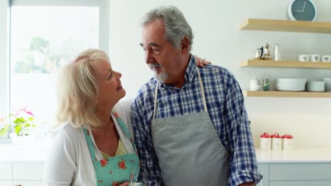 Smiling-couple-interacting-while-having-a-glass-of-wine