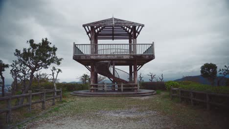 Wooden-observation-tower-in-Saikazaki,-Japan-on-a-cloudy-day-with-scenic-views-of-the-surrounding-landscape