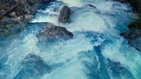 immerse yourself in the pristine beauty of the julian alps with this stunning capture of a mountain river near kranjska gora, slovenia. crystal-clear turquoise water flows over smooth river rocks.