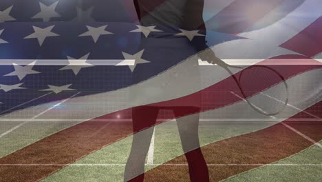 waving american flag over low section of female tennis player holding a racket against tennis court