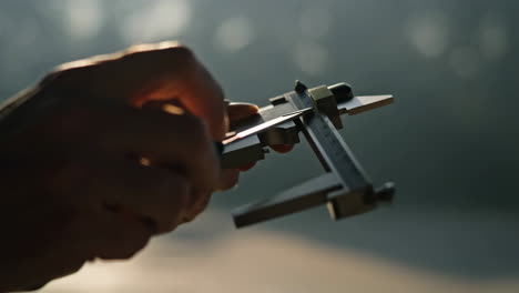 close up of a hand holding a measuring tool