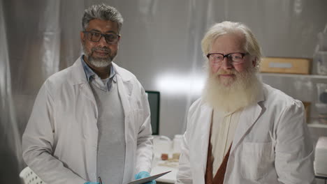 portrait of two senior archaeologists at work in research laboratory