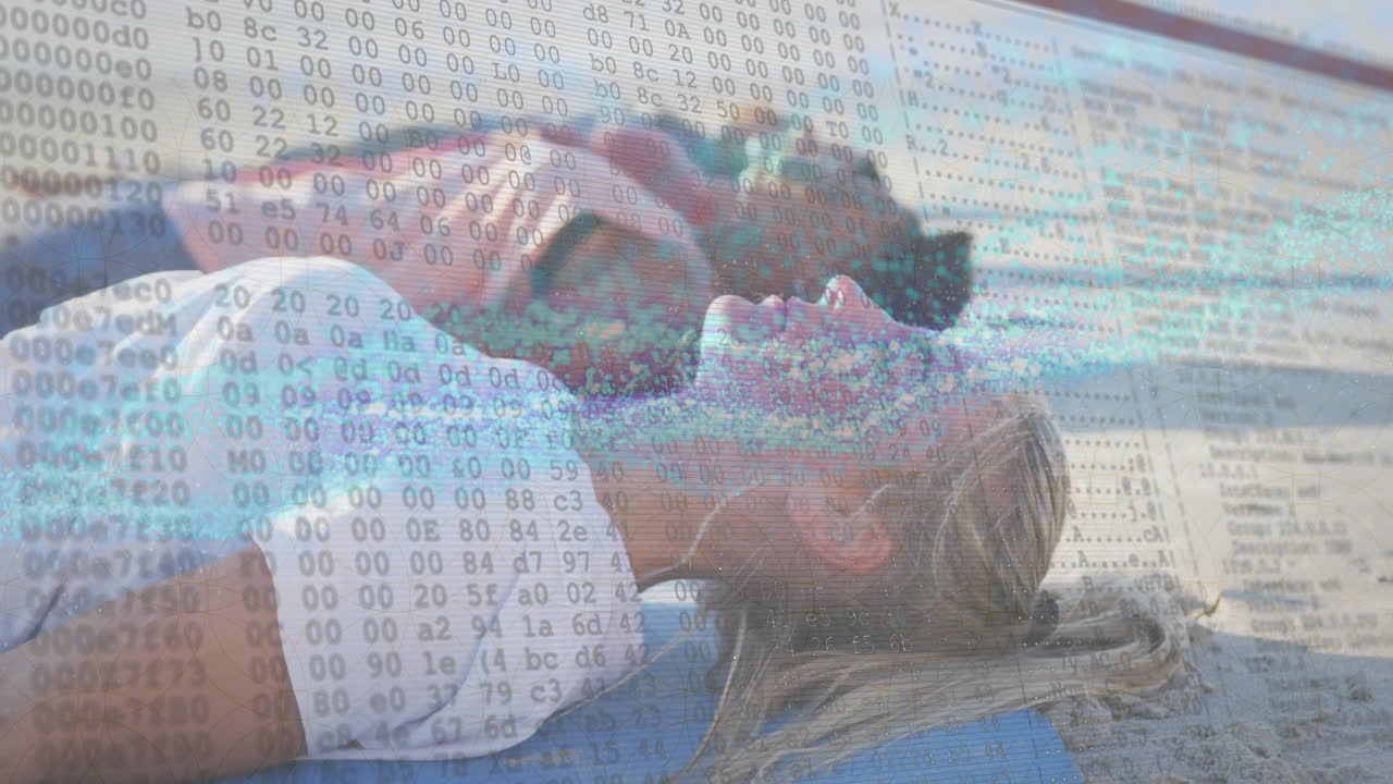 On beach, couple relaxing with digital animation overlaying scenic view