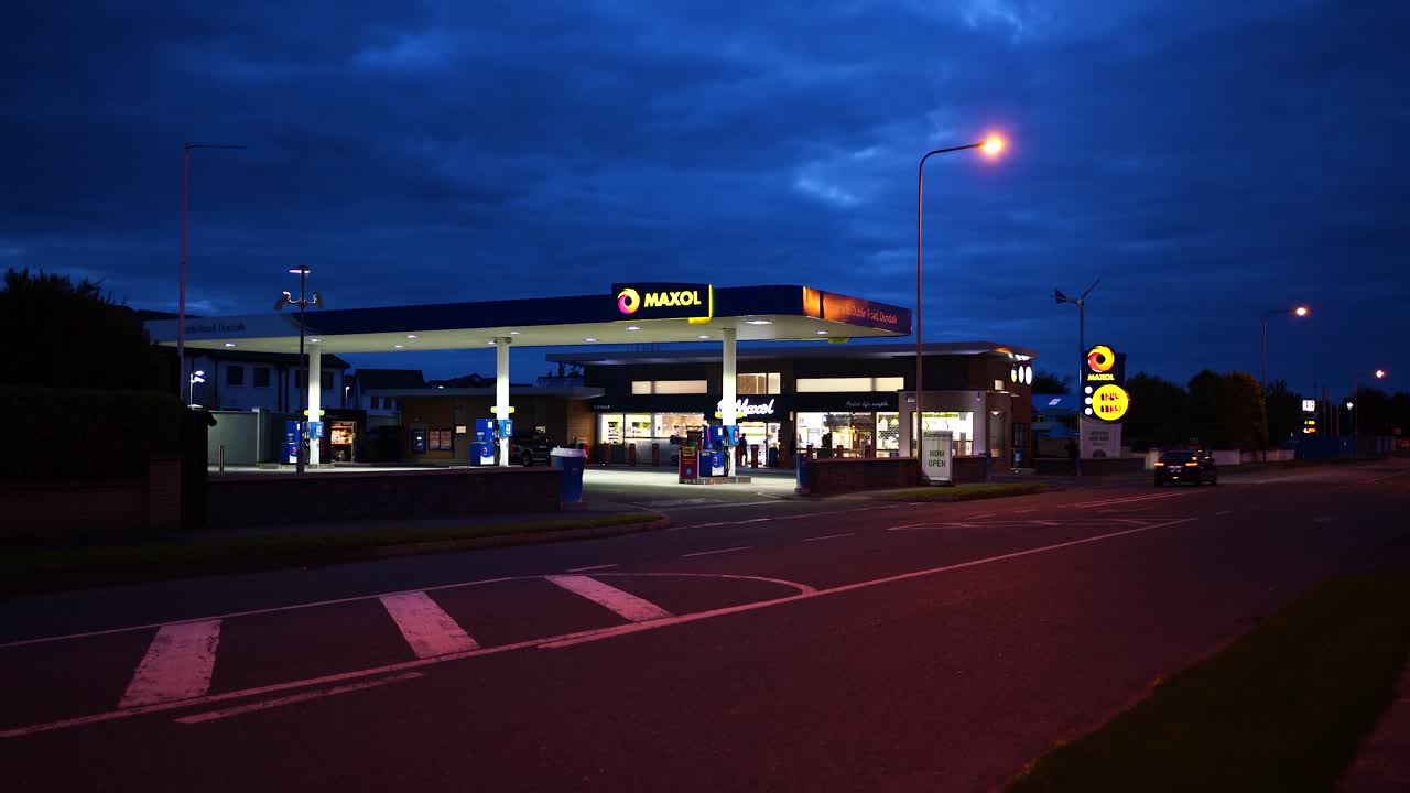 View of the gas station Maxol and the traffic on the road at night In Dundalk , Ireland