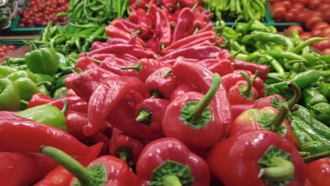 fresh red and green bell peppers at a grocery store