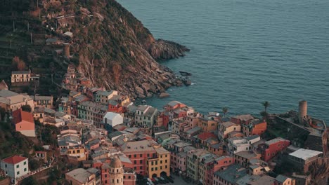 expansive aerial establishing above vernazza, cinque terre, italy, village and coastline at golden hour