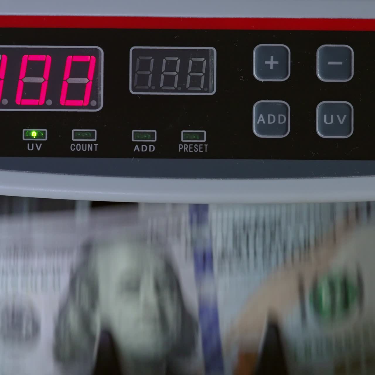 Control panel of cash counting machine. US dollars being counted in the device. Close up