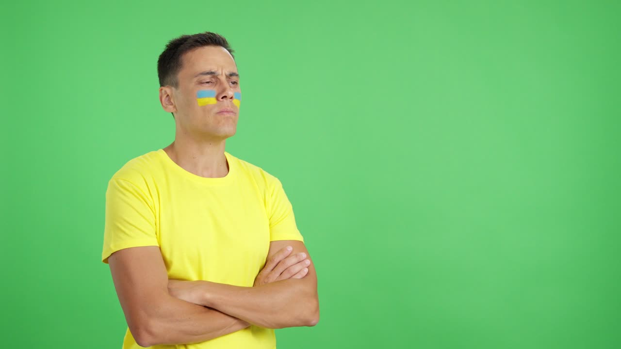 Ukrainian patriot man looking away with serious expression