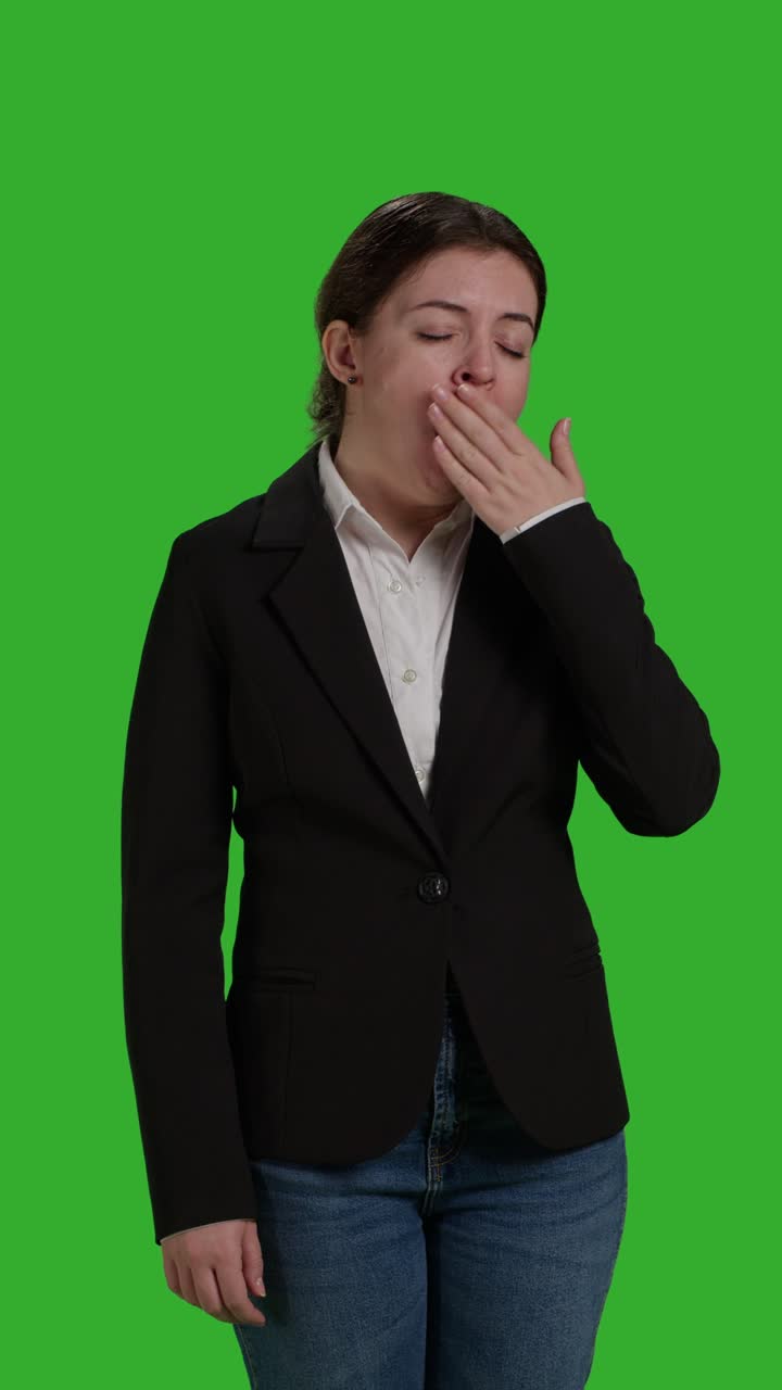 Vertical video: Front view close up of tired employee yawning and feeling fatigued
