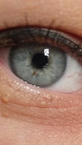 woman opening her blue eye