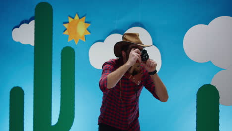 man with camera in a desert scene