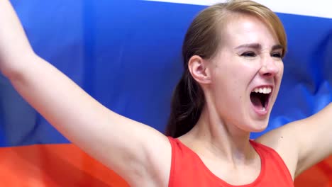 russian young woman celebrates holding the flag of russia in slow motion