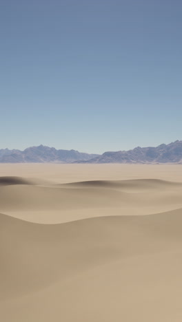 desert landscape with sand dunes and mountains in the distance