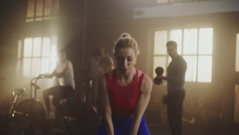 woman exercising with kettlebell in gym