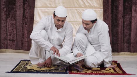 indian brother reading quran book during eid festival